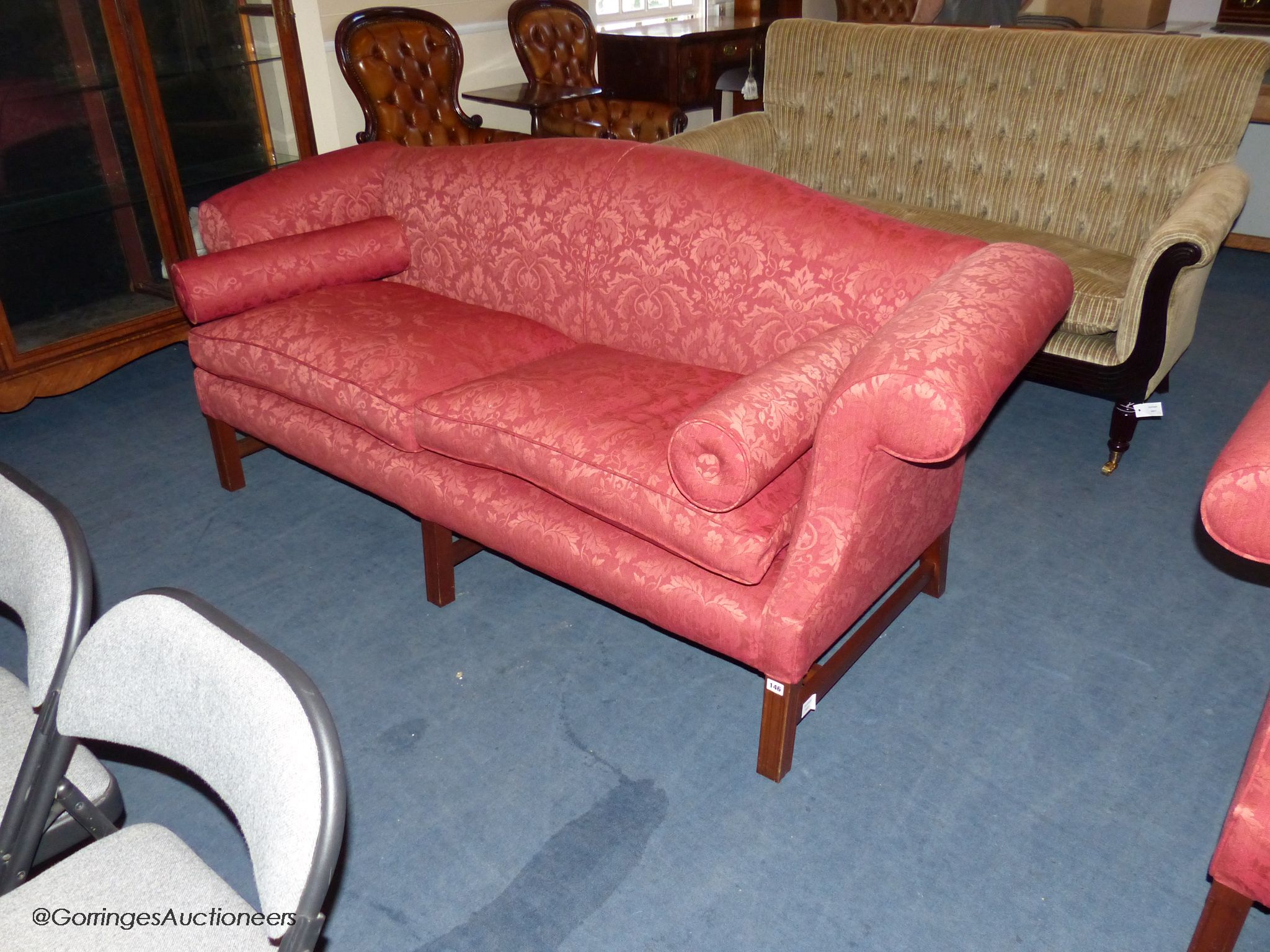 A pair of Hepplewhite style mahogany silk damask camel back sofas, 210 cm wide, with bolster cushions